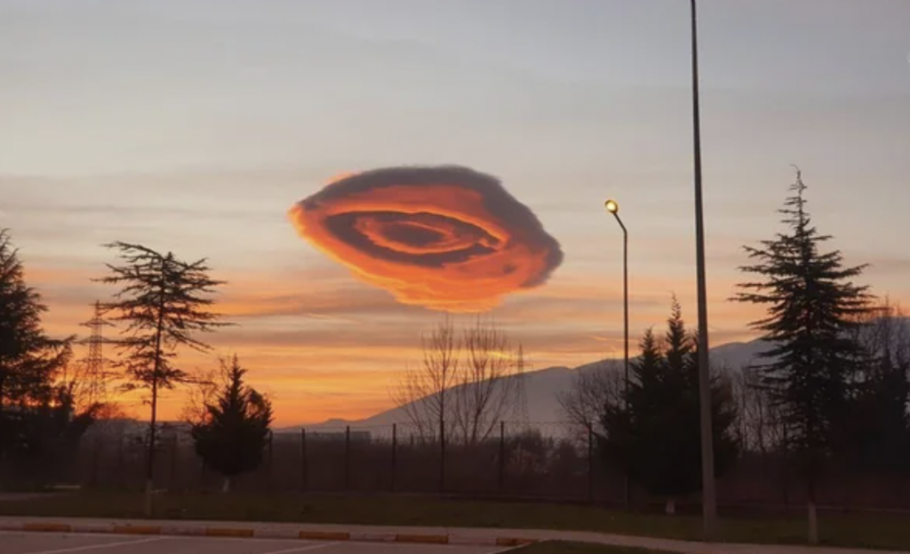 An image of a strangely shaped pink cloud.