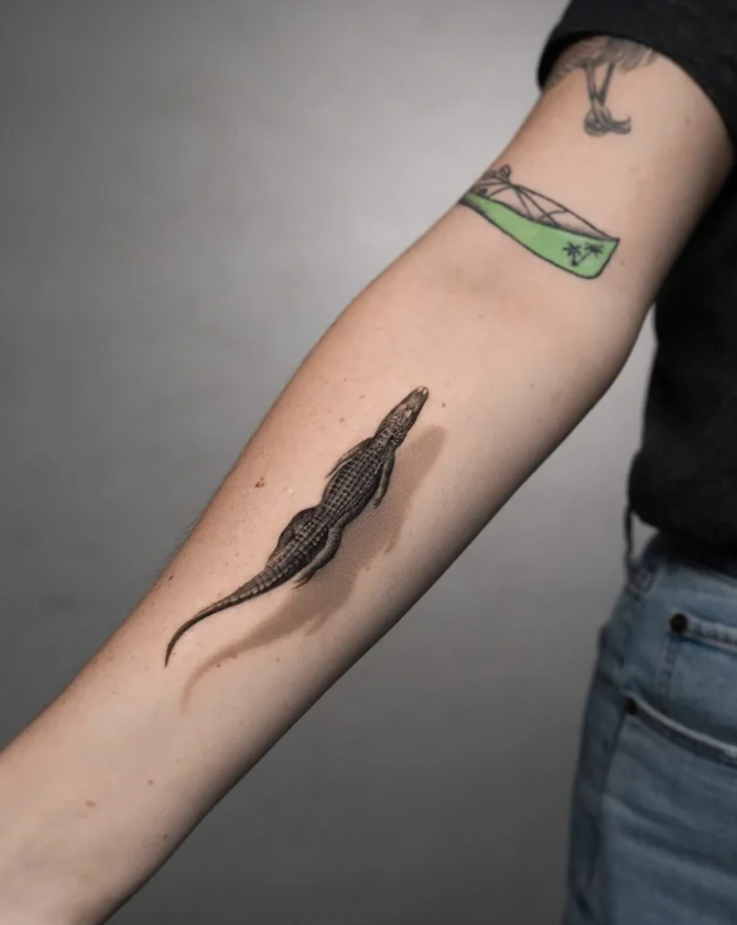 An oddly satisfying image of a crocodile tattoo that is floating upstream.