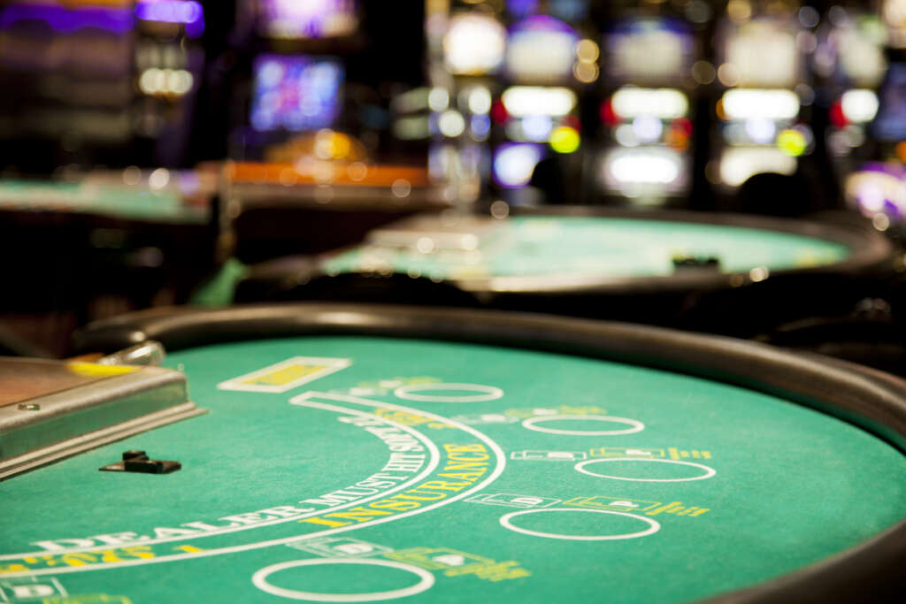 A close-up image of a blackjack table inside of a casino. 