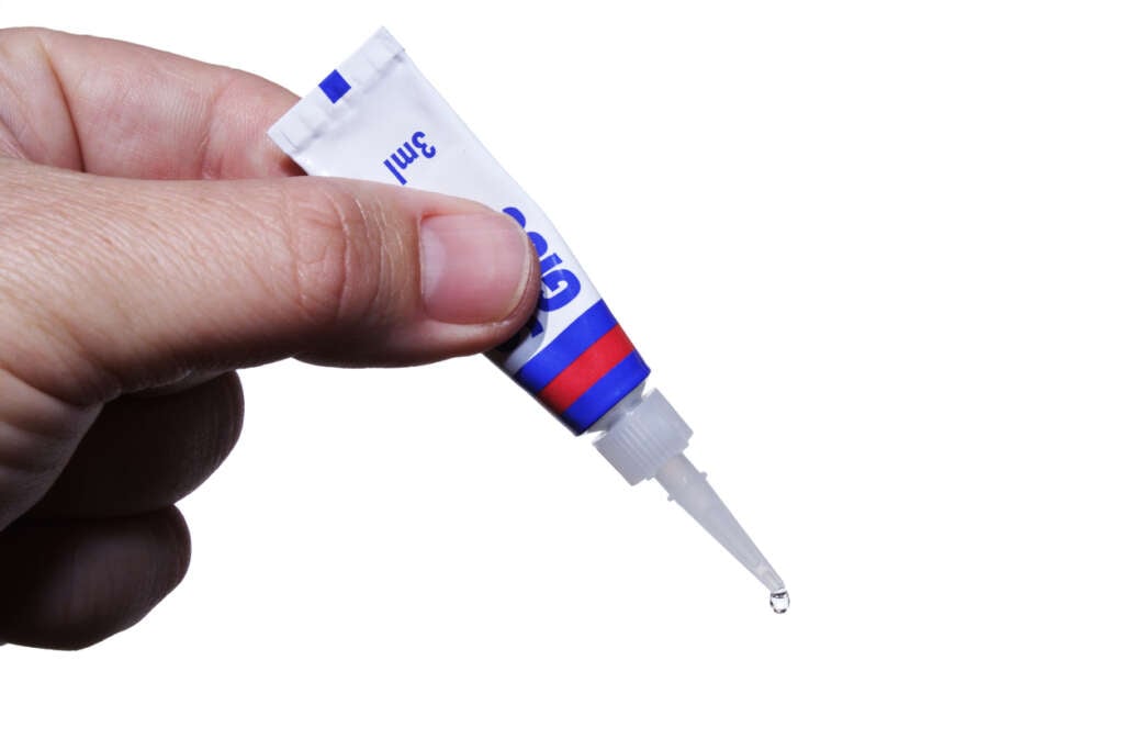 A close-up image of a tiny glue dispenser. 