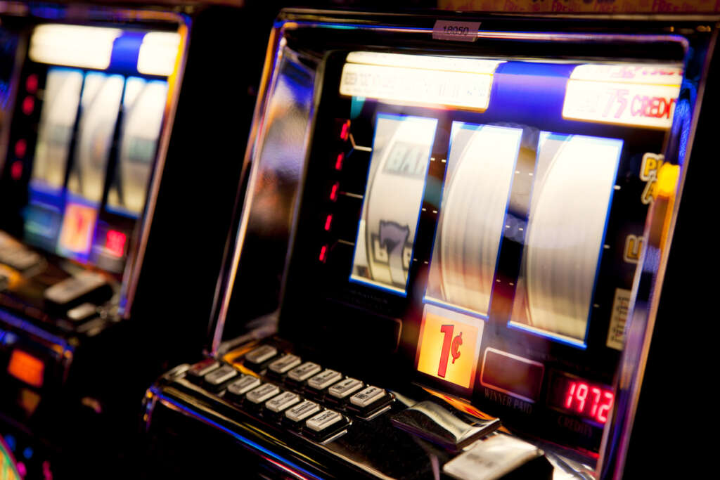 Close-up image of a slot machine that's been pulled and is in motion. 