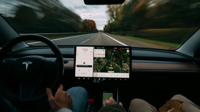 An image of someone using GPS navigation while driving their Tesla.