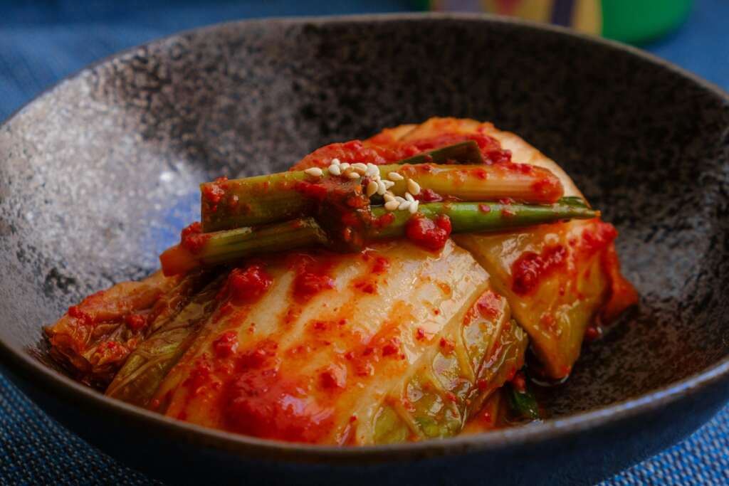 An image of kimchi over chicken. 