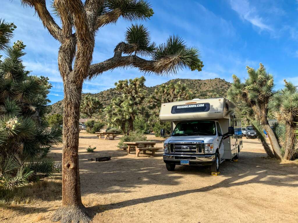 An image of an RV in a desert. 