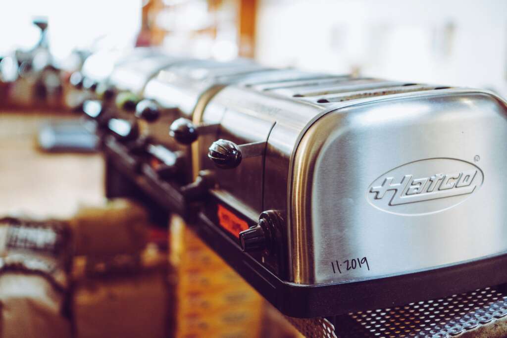 A close-up image of toasters lined up next to each other. 