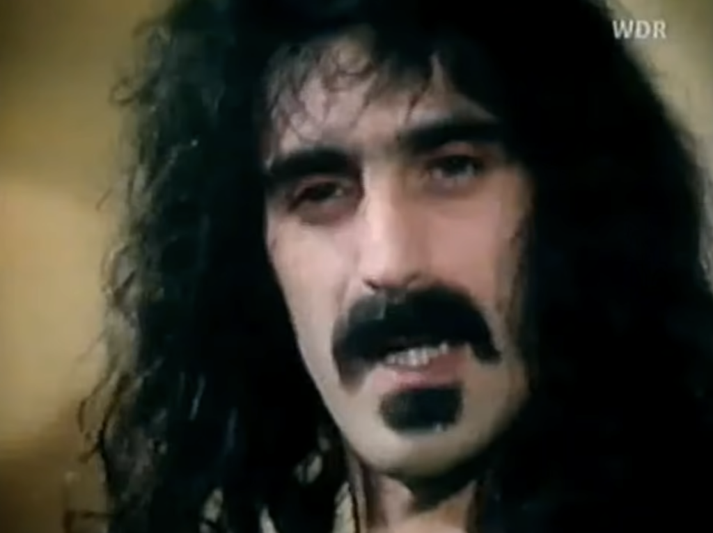 Frank Zappa with long hair on a television interview