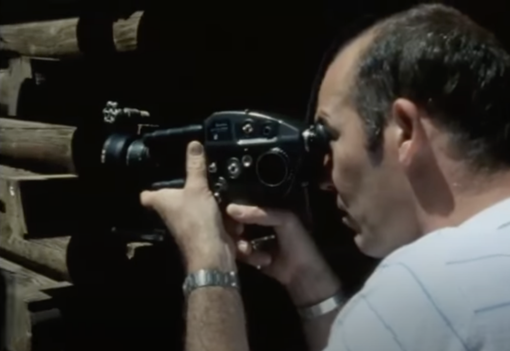An image of Hunter S. Thompson using a film camera. 