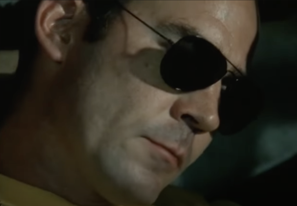 An image of Hunter S. Thompson wearing sunglasses. 