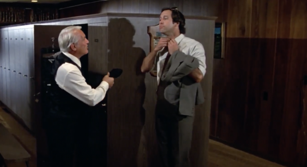An image of Chevy Chase's character talking to Smails in the locker room in Caddyshack. 