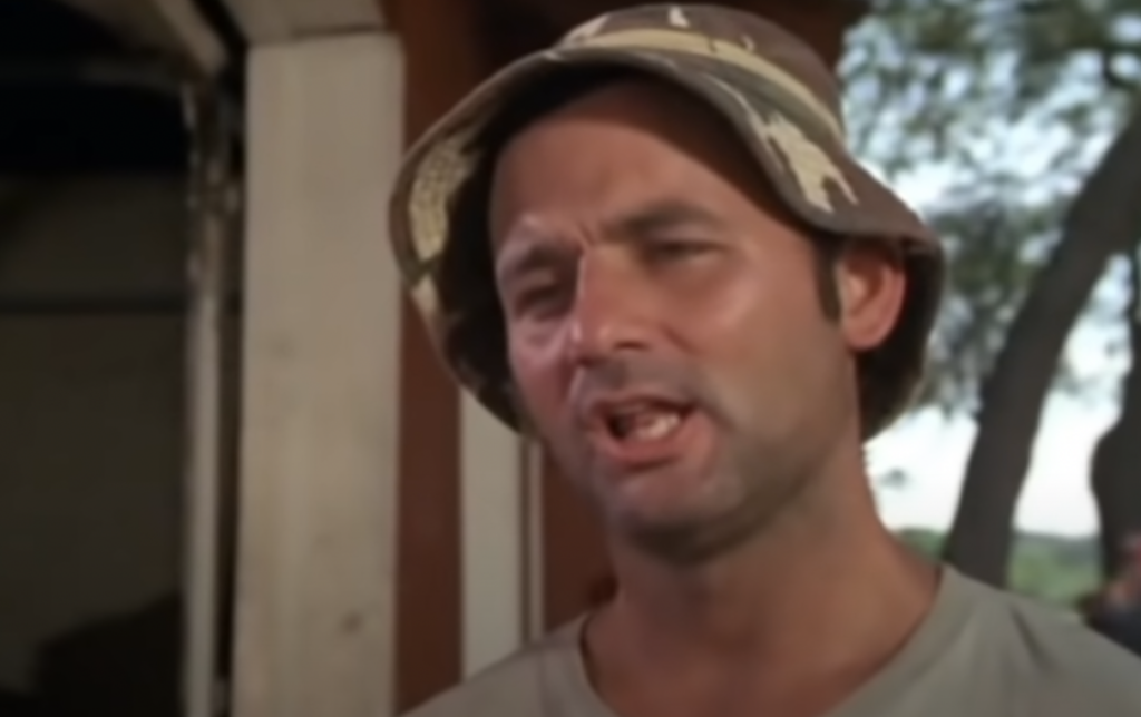 An image of Carl Speckler in Caddyshack talking about caddying for the Dalai Llama. 