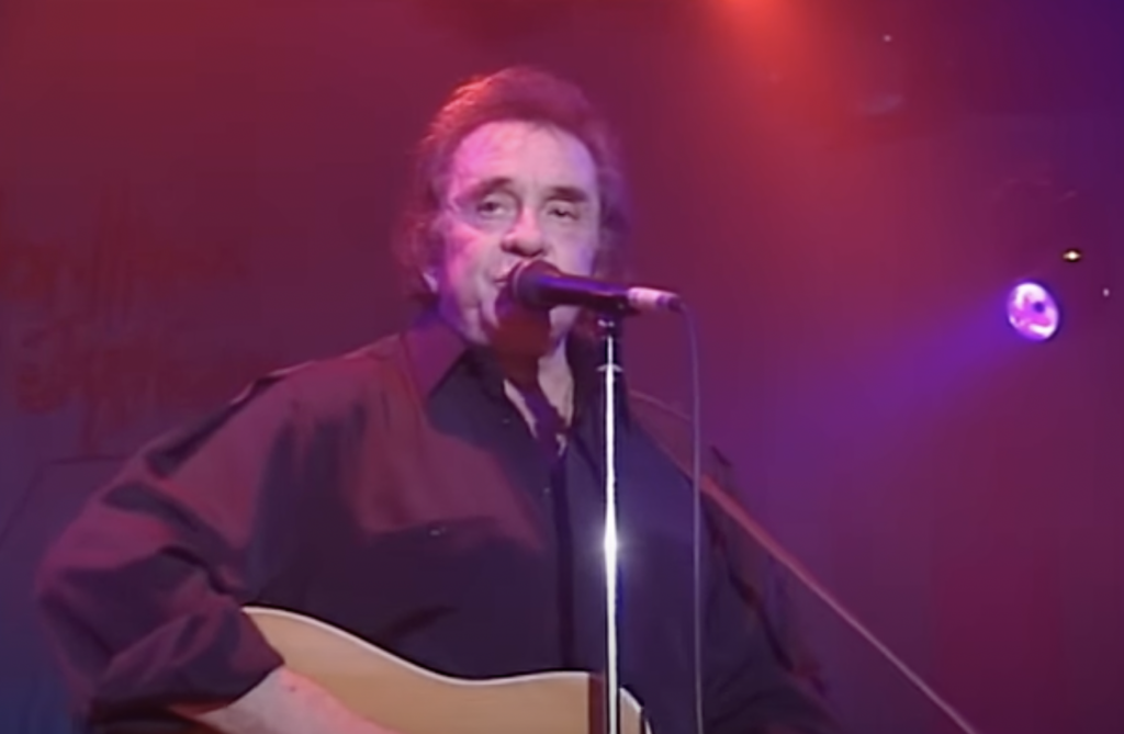 Johnny Cash when he was older, singing on stage. 