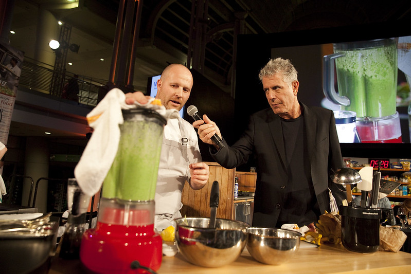 An image of Anthony Bourdain holding up a microphone. 