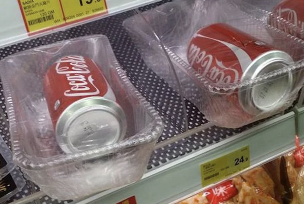 A couple of Coke cans that have been individually wrapped. 