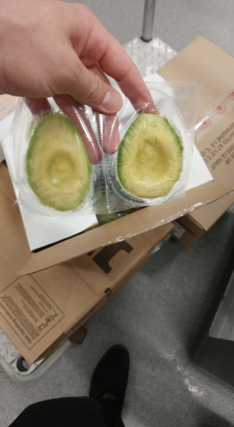 A couple of peeled avocados that have been wrapped in plastic. 