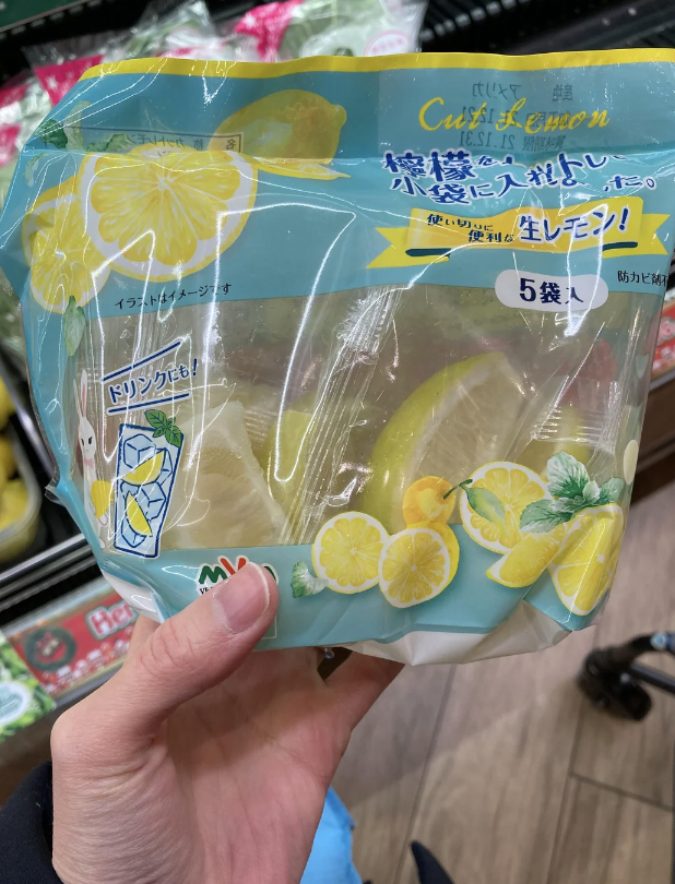 A bag filled with individually wrapped lemon slices. 