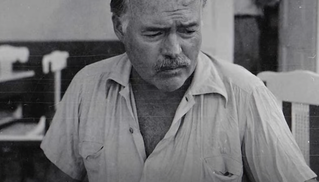 An older Ernest Hemingway with a mustache. 