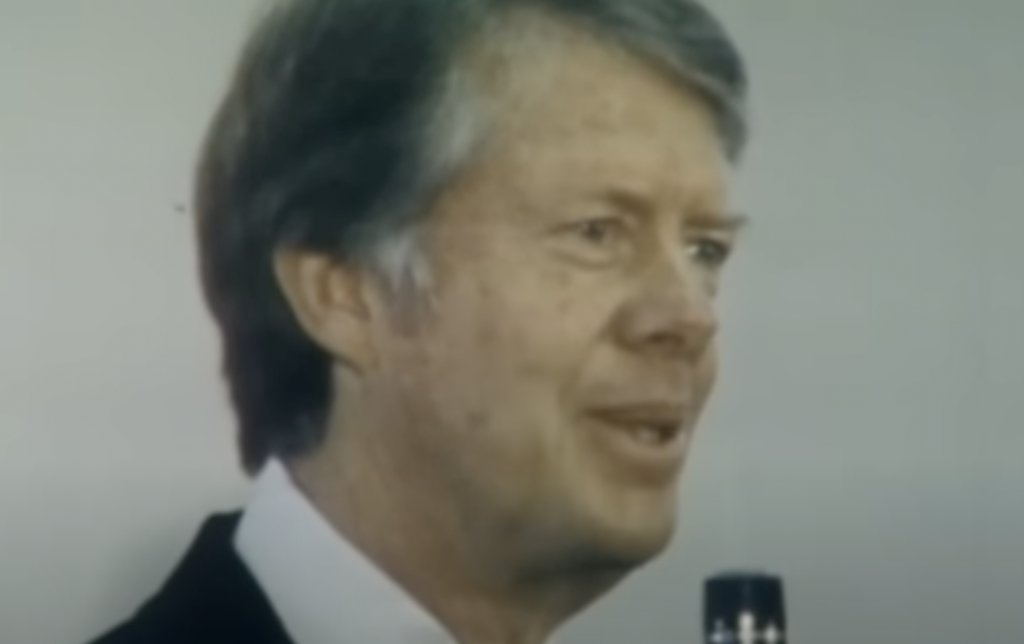 Jimmy Carter talking into the mic. 