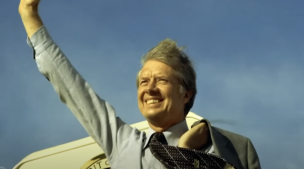 Jimmy Carter waving while getting off Air Force 1. 