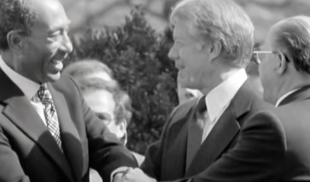 An image of Jimmy Carter shaking hands. 