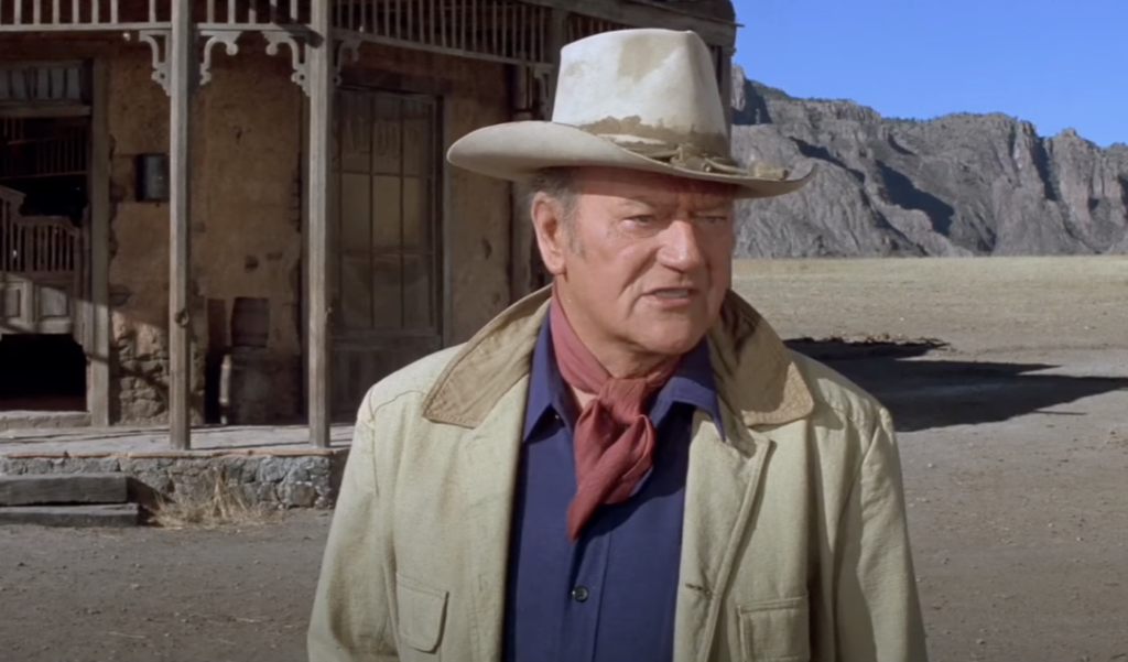 A still image of John Wayne talking. 