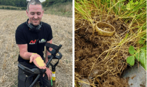 A man in a field holding several gold coins, smiling, with a metal detector next to him. To the right, a close-up of a gold ring partially buried in the grass and soil.