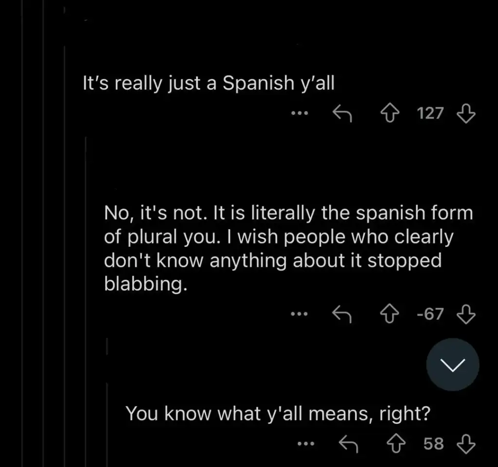 Screenshot of a social media thread. The first comment says, "It's really just a Spanish y'all," with 127 upvotes. A reply disagrees, explaining the Spanish form of plural you, with -67 votes. A third comment asks, "You know what y'all means, right?" with 58 votes.