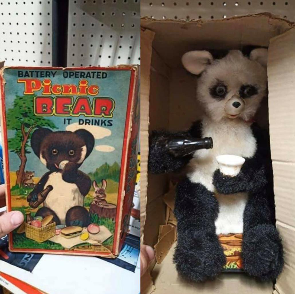 A vintage toy box labeled "Picnic Bear" shows a cartoon bear having a picnic. Next to it is the actual battery-operated toy bear, holding a bottle and a cup inside a worn cardboard box.
