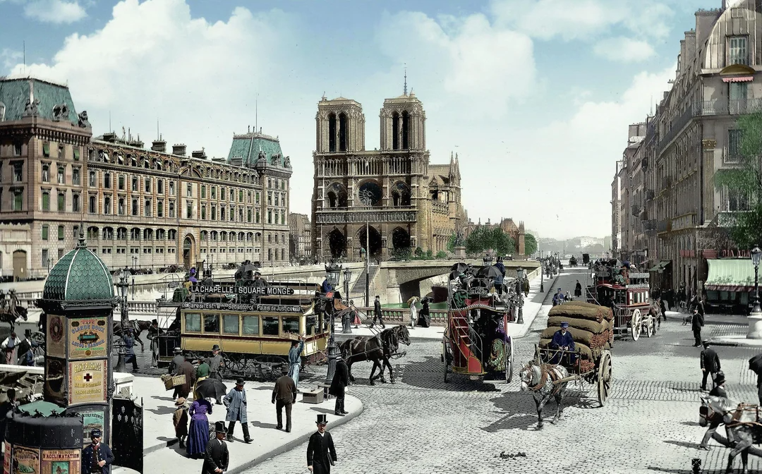 A busy 19th-century Paris street scene with horse-drawn carriages, pedestrians, and a tram near Notre-Dame Cathedral. Historic buildings and lively urban activity fill the foreground.