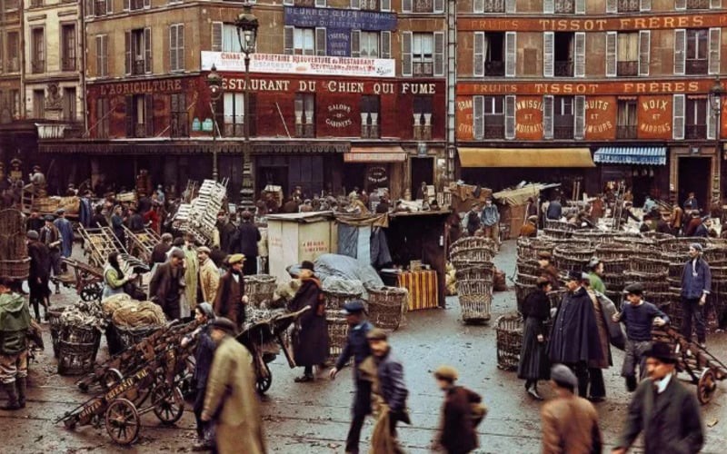 A busy street market scene in an old European city, with people walking, vendors selling goods, and large baskets scattered around; historic buildings with French signs line the background.