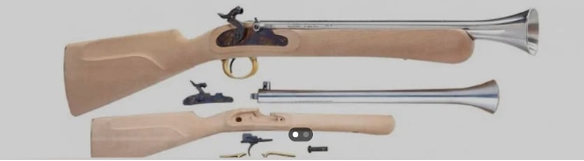 A disassembled flintlock blunderbuss with a wooden stock and metal barrel, shown with its main components including the lock, barrel, stock, trigger, and small metal parts, laid out on a light background.