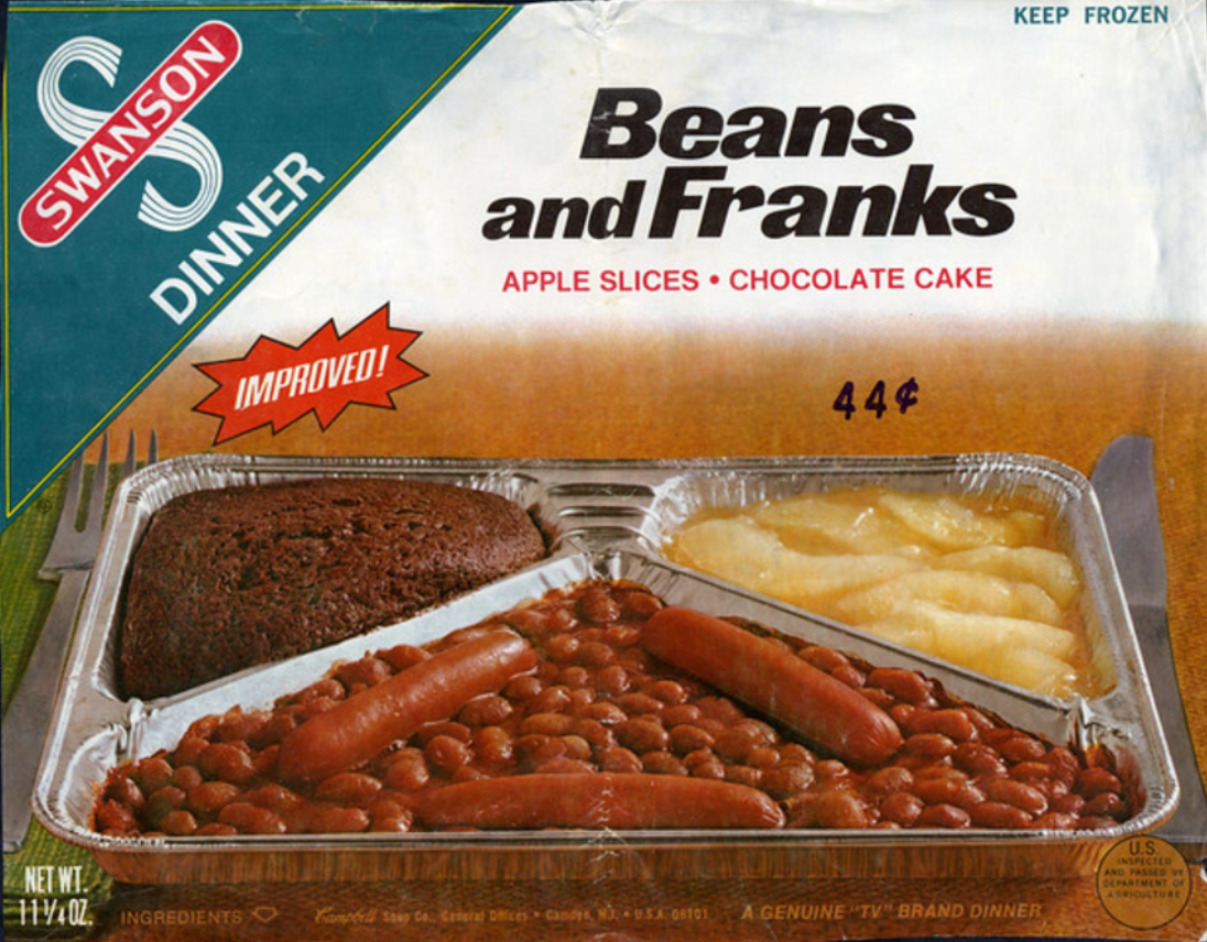 A vintage Swanson TV dinner box labeled "Beans and Franks" shows a meal with baked beans and hot dogs, apple slices, and a piece of chocolate cake in a divided tray. The package advertises "Improved!" and costs 44 cents.