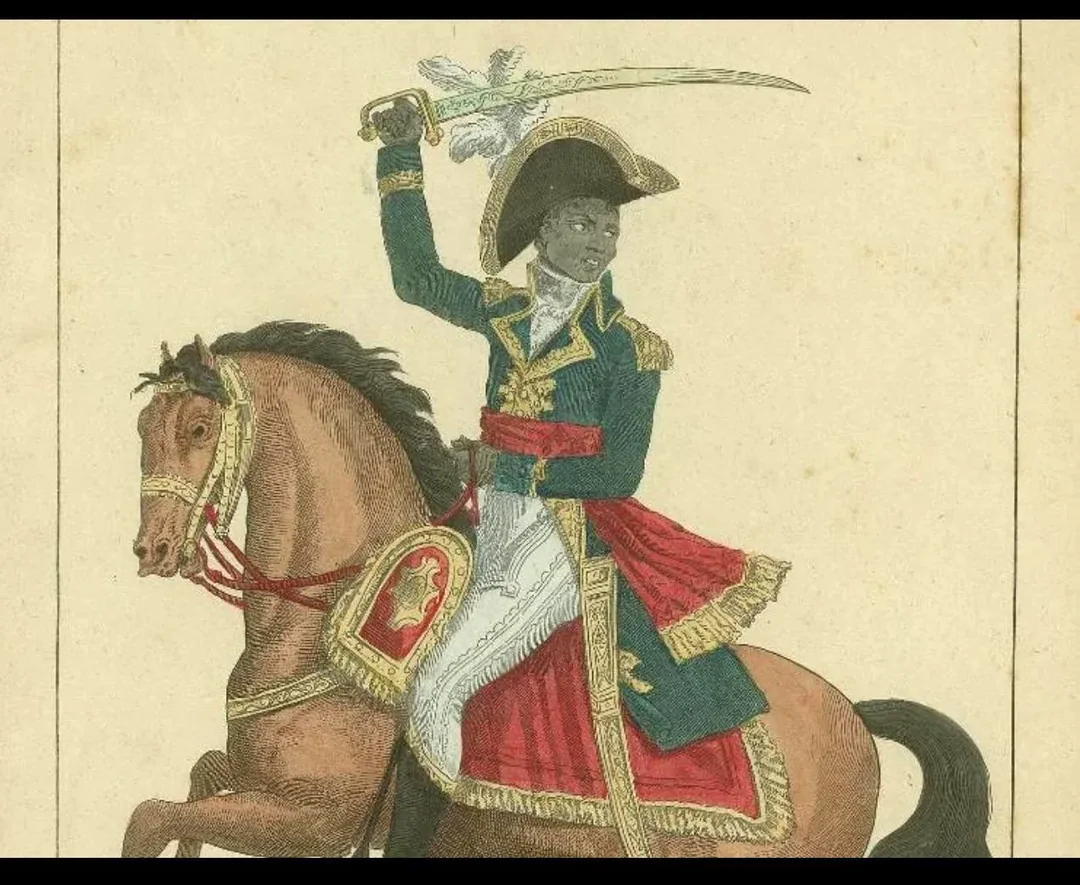 A Black man in a decorated military uniform rides a brown horse, holding a raised sword. He wears a large hat with a white feather and is depicted in a historical, triumphant pose.