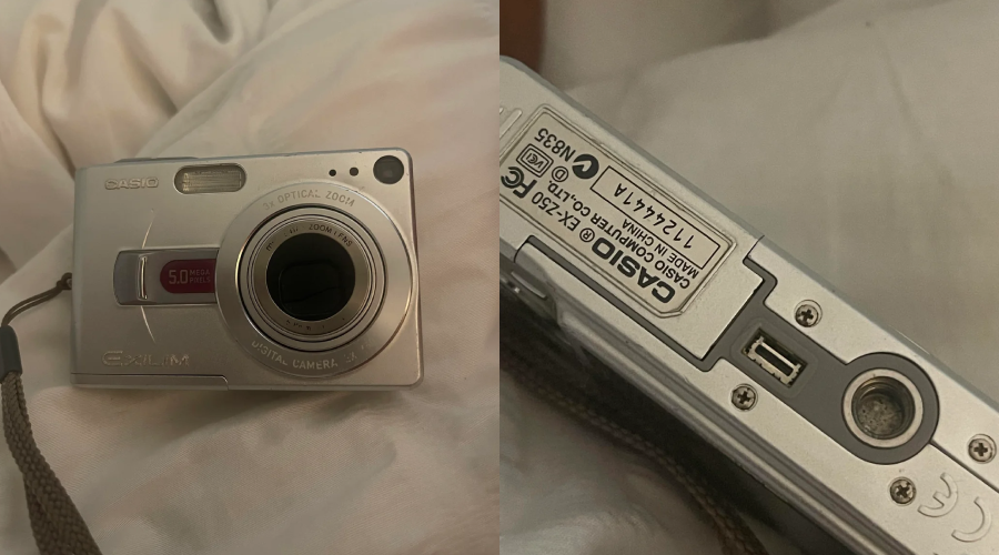 A silver Casio Exilim digital camera is shown from the front and bottom, displaying its lens, buttons, and model information while resting on a light-colored fabric surface.