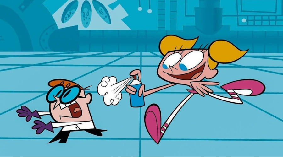 A cartoon boy with glasses and a lab coat recoils in shock as a girl with blonde pigtails sprays him with liquid in a blue laboratory. Both characters have exaggerated, playful expressions.