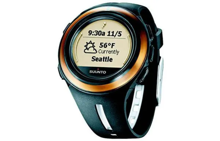 A black and gold Suunto smartwatch displays the time 9:30 AM, the date 11/5, a weather icon, temperature 56°F, and "Currently Seattle" on its round digital screen.