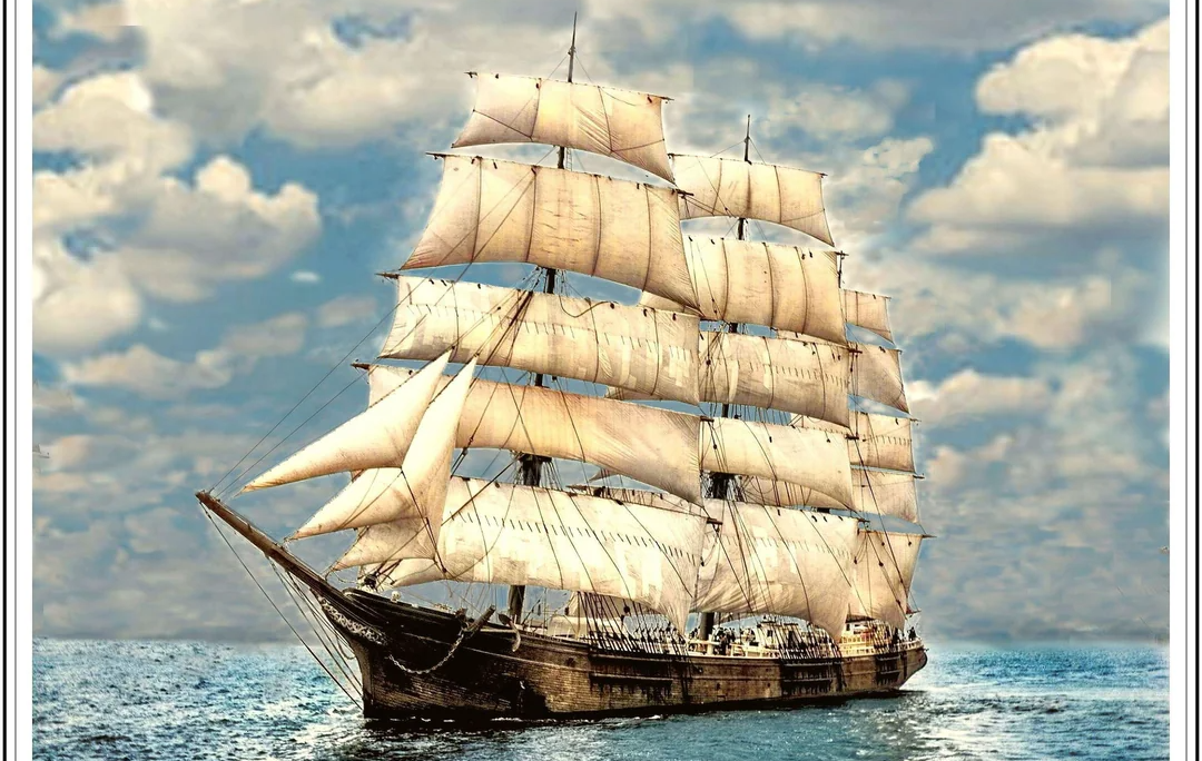 A large wooden sailing ship with multiple masts and white sails glides across a calm blue sea under a partly cloudy sky.