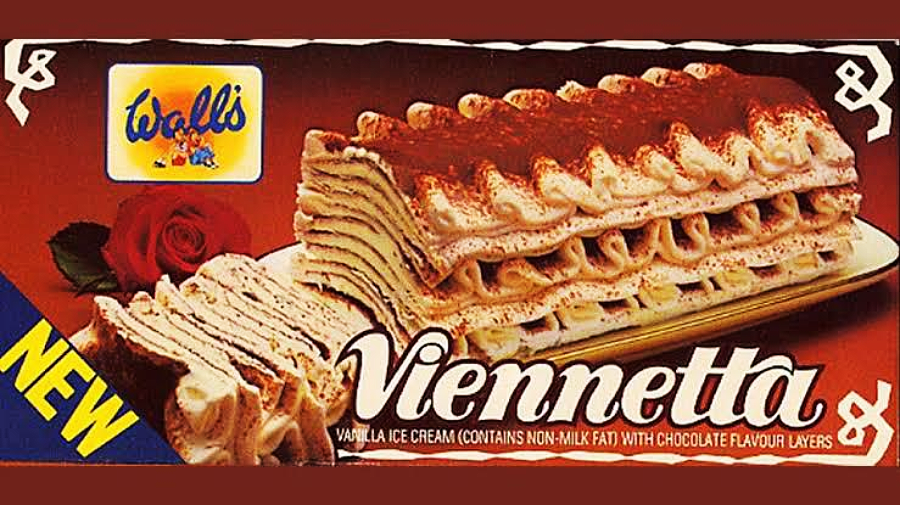Box of Wall’s Viennetta vanilla ice cream cake with chocolate layers, featuring a close-up image of the cake, a red rose, and the words “NEW” and “Viennetta” prominently displayed on the packaging.
