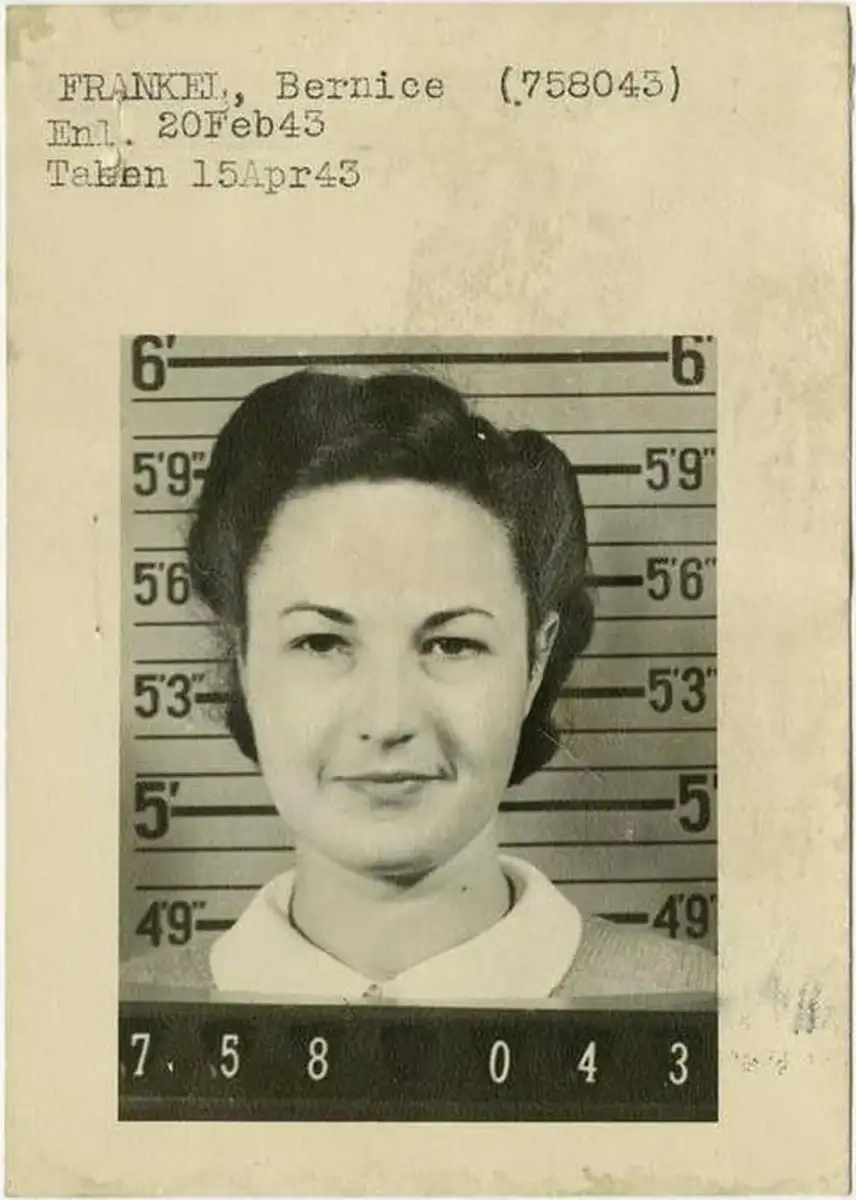 Black and white mugshot-style photo of a woman in front of a height chart. Text above reads: "FRANKEL, Bernice (758043), Enl. 20Feb43, Taken 15Apr43." Number 758043 is displayed below the photo.