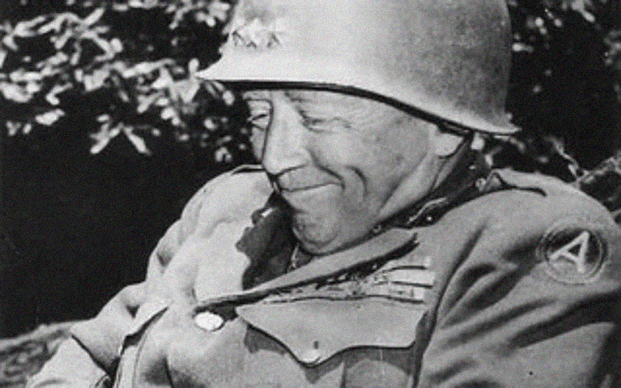 A World War II-era soldier in uniform and helmet smiles with eyes closed, seated outdoors with foliage in the background. Medals and insignias are visible on his jacket.