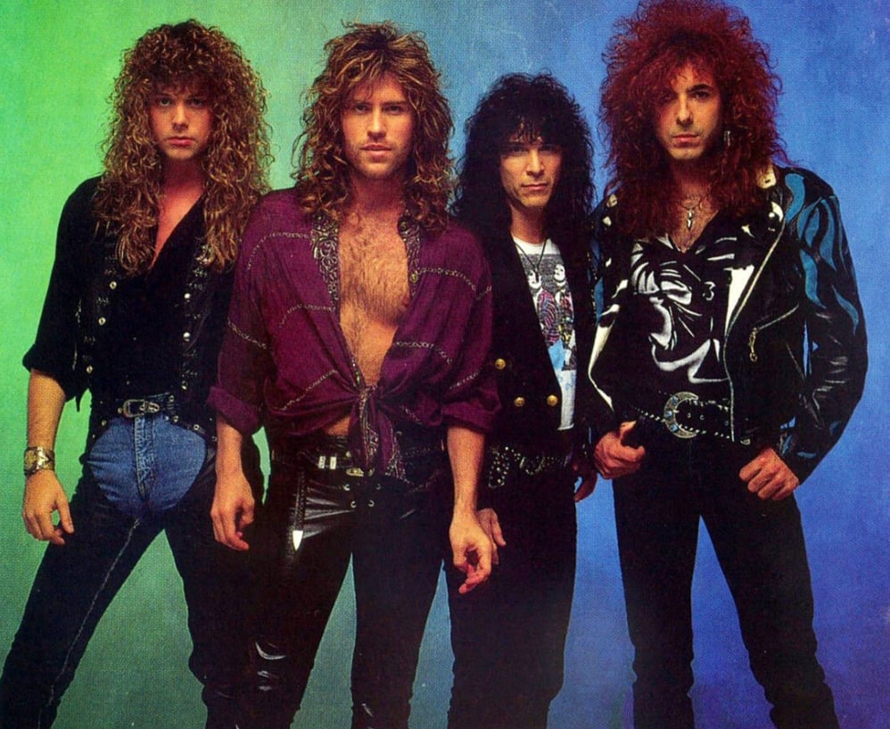 Four men with long, voluminous 1980s-style hair stand together against a green and blue gradient background, wearing leather pants, open shirts, and jackets with a rock band aesthetic.