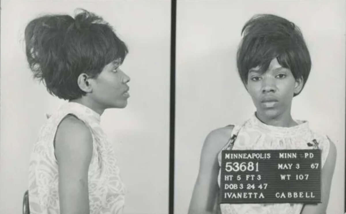Black and white mugshot of a woman in a sleeveless top; side and front views. She holds a placard with her name, Ivanetta Cabbell, and booking details from the Minneapolis Police Department, dated May 3, 1967.