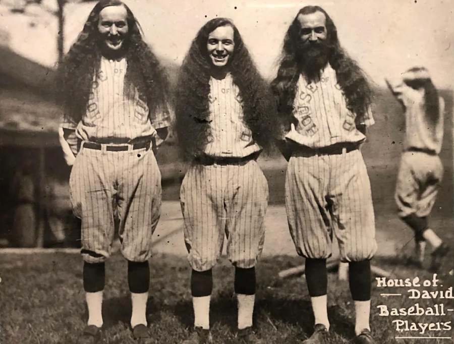 Three baseball players with very long hair and beards stand side by side in vintage uniforms that read "House of David." The text "House of David Baseball Players" is written in the lower right corner.