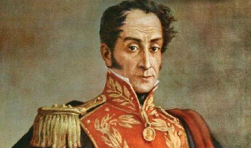 A painted portrait of a man in an ornate red military uniform with gold embroidery and shoulder epaulettes, looking directly at the viewer. The background is neutral and plain.