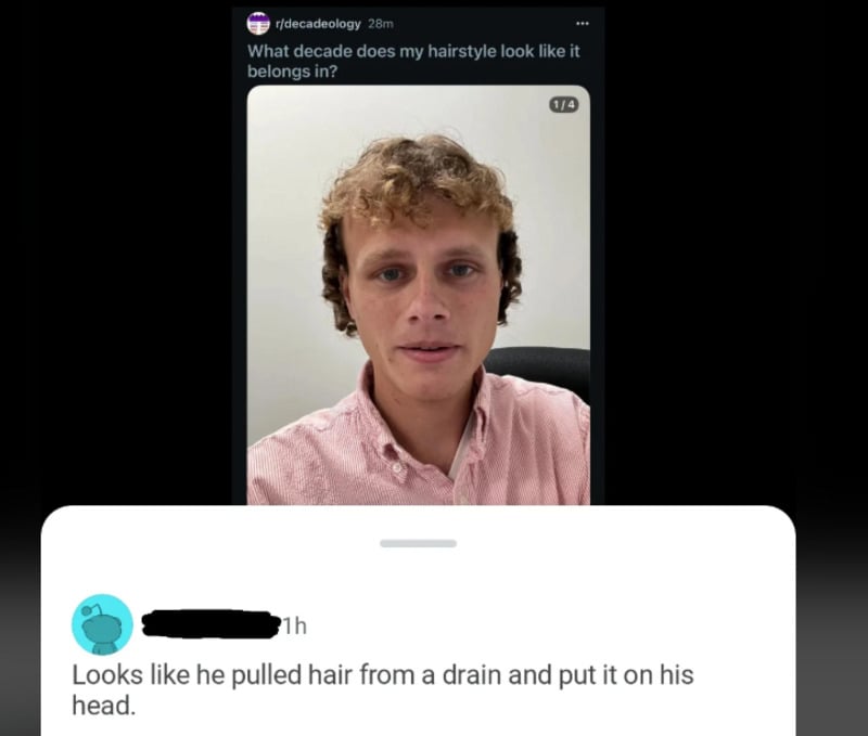 A young man with curly, messy blond hair and a pink shirt poses for a selfie. Above him is the question, "What decade does my hairstyle look like it belongs in?" Below, a comment jokes his hair looks like it was pulled from a drain.