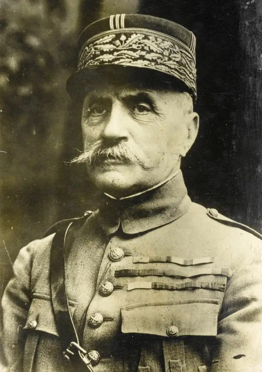 A distinguished older man in a military uniform with medals and a decorative cap. He has a prominent mustache and a serious expression, looking slightly to the side in this black-and-white photograph.