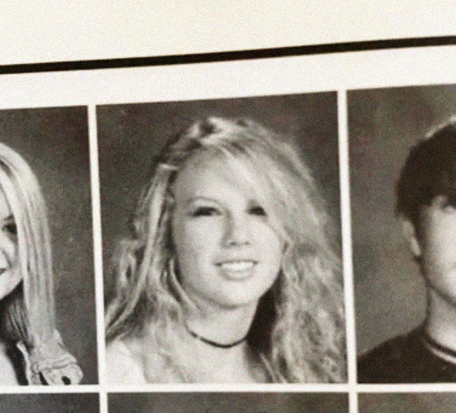 A black-and-white school yearbook photo shows a young person with long wavy hair, a slight smile, and wearing a choker necklace, centered between two other partially visible portraits.