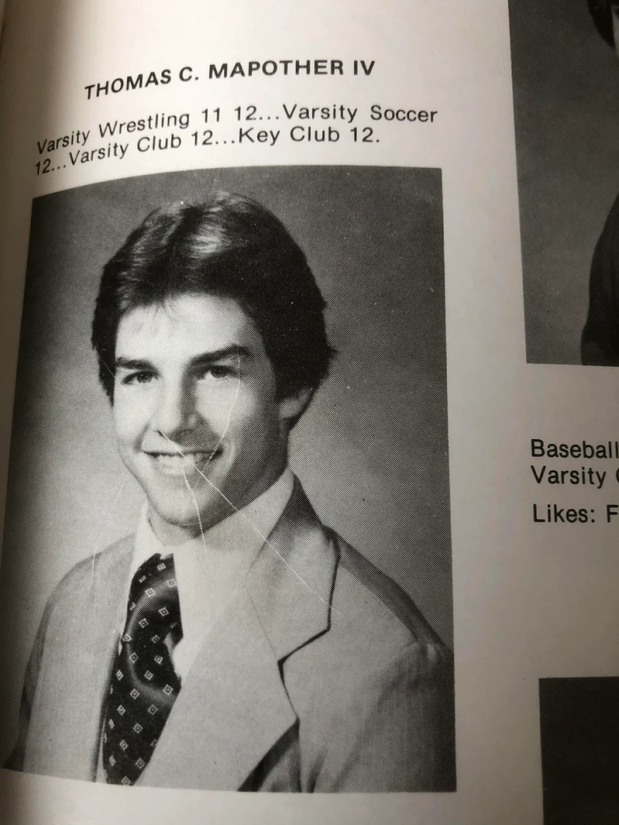 Black and white yearbook photo of a young man in a suit and tie, smiling. Text above reads “THOMAS C. MAPOTHER IV,” with activities listed: Varsity Wrestling, Soccer, Varsity Club, and Key Club, along with class years.