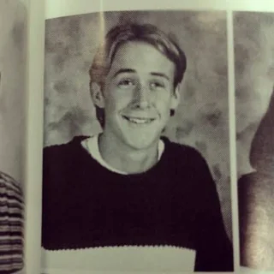 A black-and-white yearbook photo of a teenage boy with light hair, wearing a dark sweater over a light shirt, smiling at the camera against a neutral backdrop.