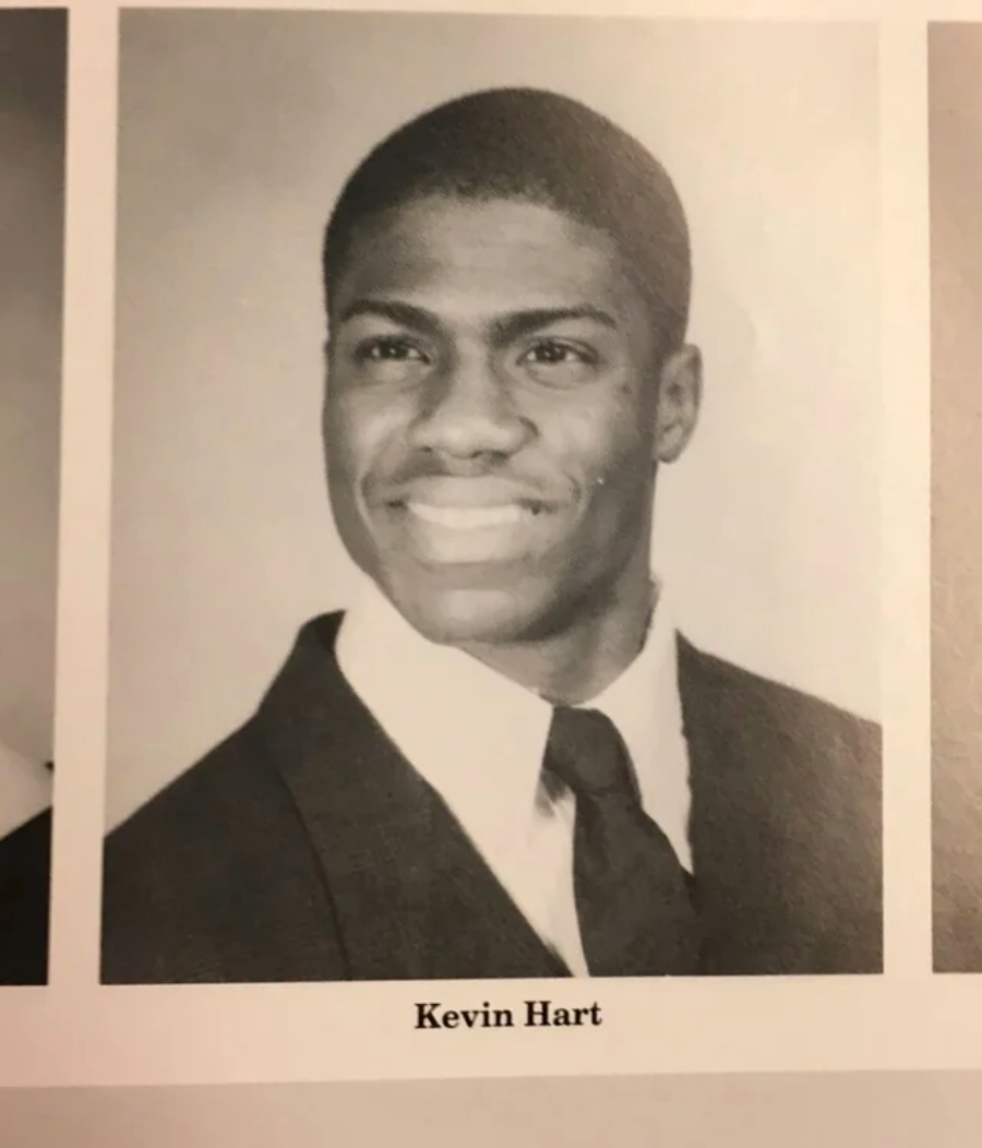 Black and white yearbook photo of a young man in a suit and tie, smiling, with the name "Kevin Hart" printed below the image.