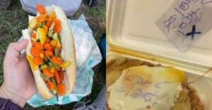 A hand holds a hot dog bun filled with pickled vegetables. Next to it, a takeout container holds a meal topped with melted cheese and a handwritten note inside a plastic bag.
